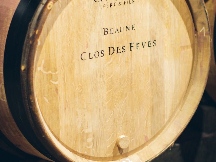 Close-up of a wooden wine barrel labeled 'Beaune Clos Des Feves'.